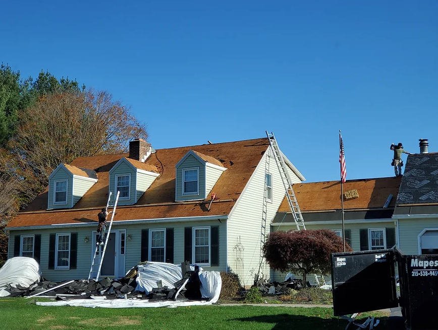 Image of home undergoing roof replacement with the current roof removed