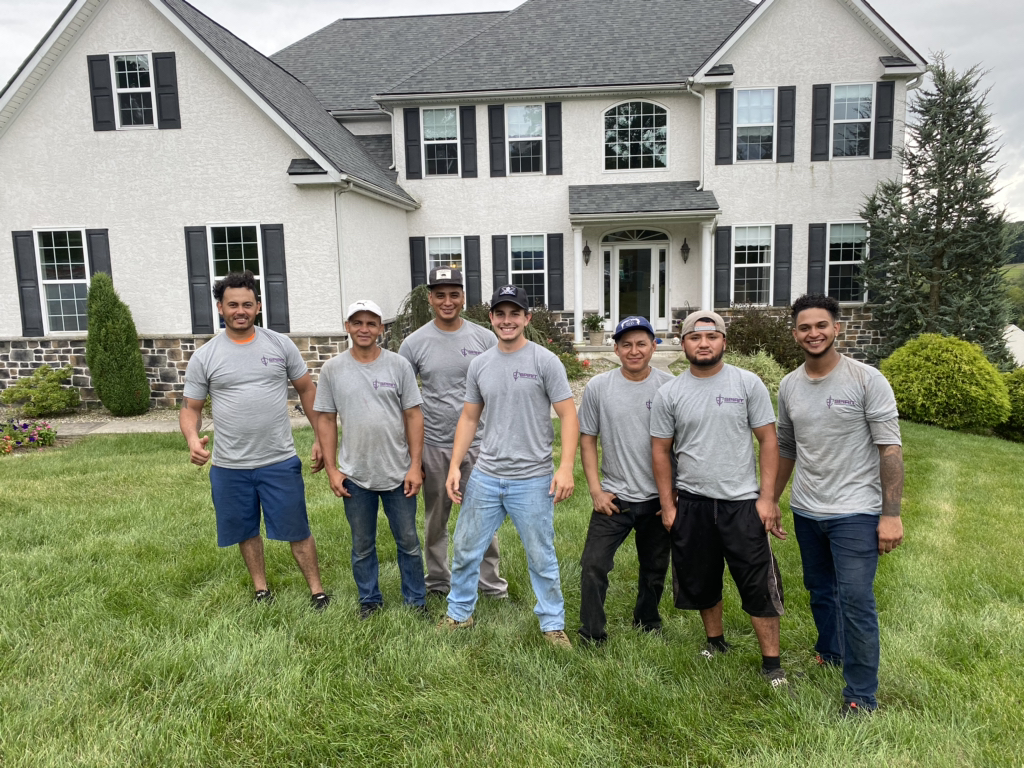 Group of San Antonio roof repair experts in front of a home they just replaced the roof on. 